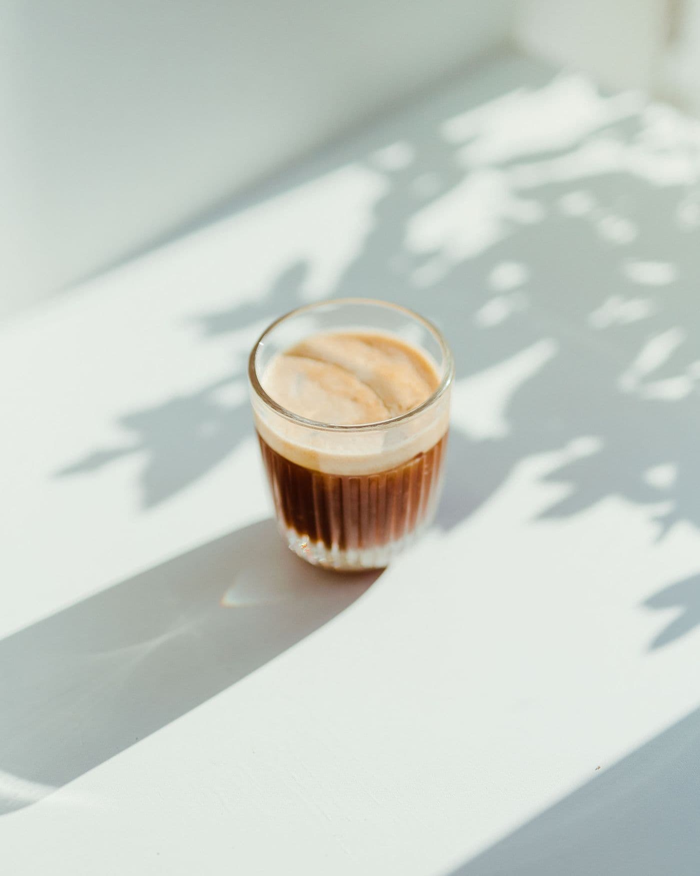 A glass of iced coffee in the morning sun